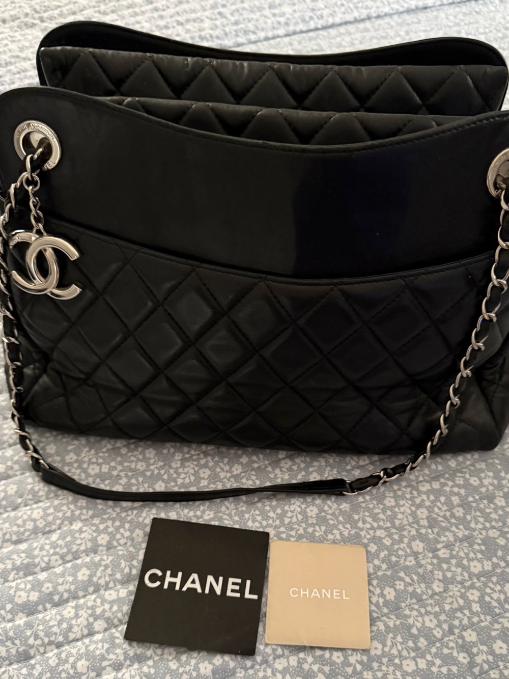 CHANEL Black Quilted Leather Shoulder Bag with Silver Chain and CC Charm